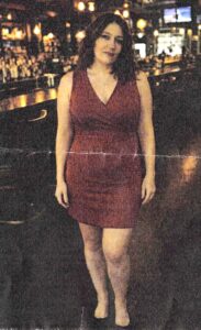 Angelina Omara wearing dress inside of a bar