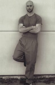 Brandon Bare standing with arms crossed